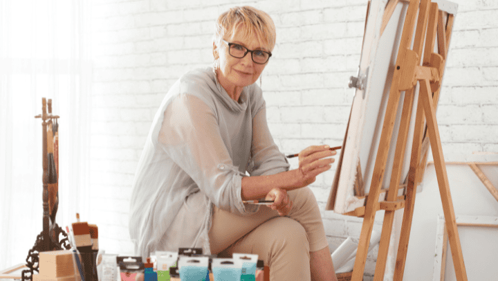 An Old Lady Painting In A Canvas