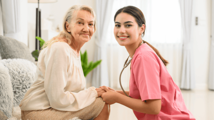A Senior Lady With Her Caregiver Holding Hands